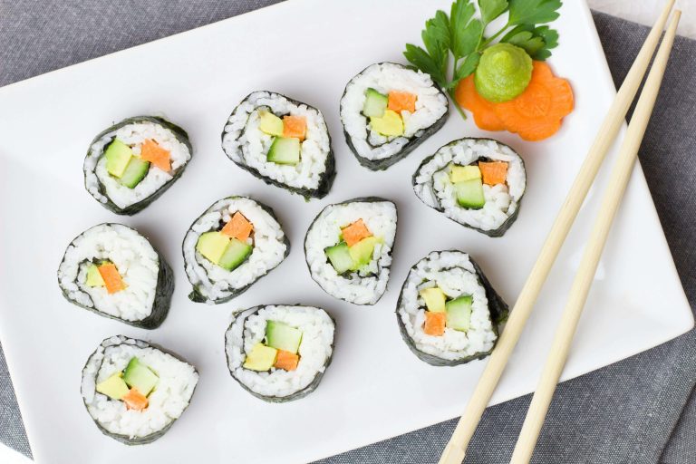 Crab and avocado sushi rolls arranged on a plate
