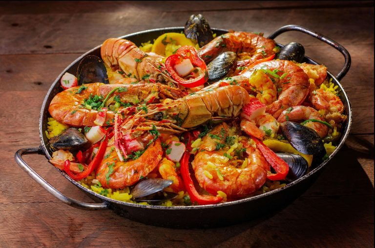 A dish of seasoned rice, seafood, and vegetables