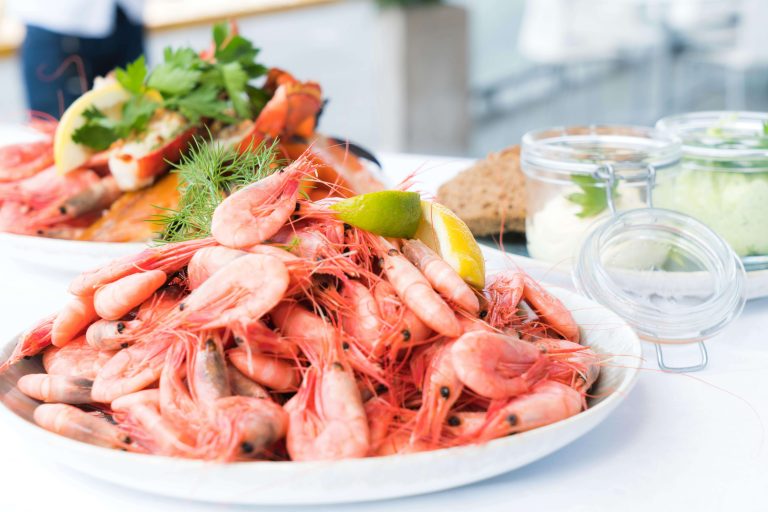 A dish of whole shrimp garnished with citrus